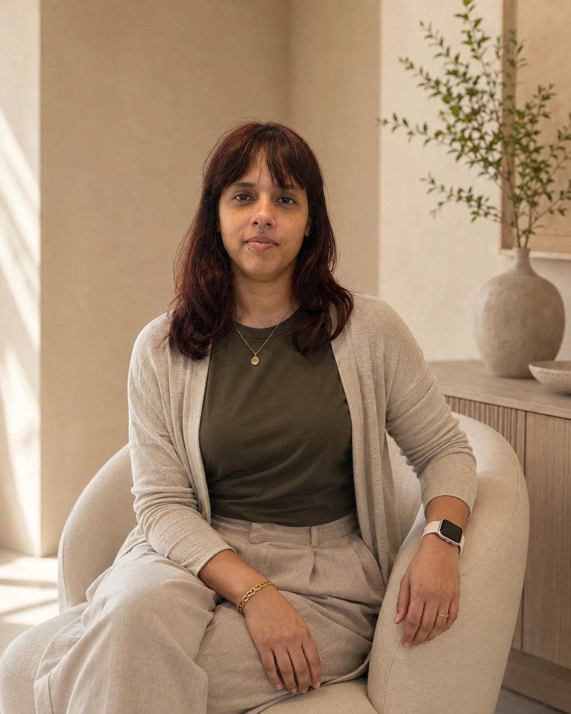 Monika, founder of MonikaSphere, seated in her studio
